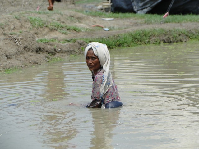 Rohinga woman standing in flood water