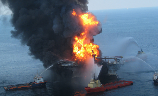 SkyTruth aerial photo of tankers trying to put of flames after Deepwater Horizon explosion, billowing black smoke plumes over oil rig explosion