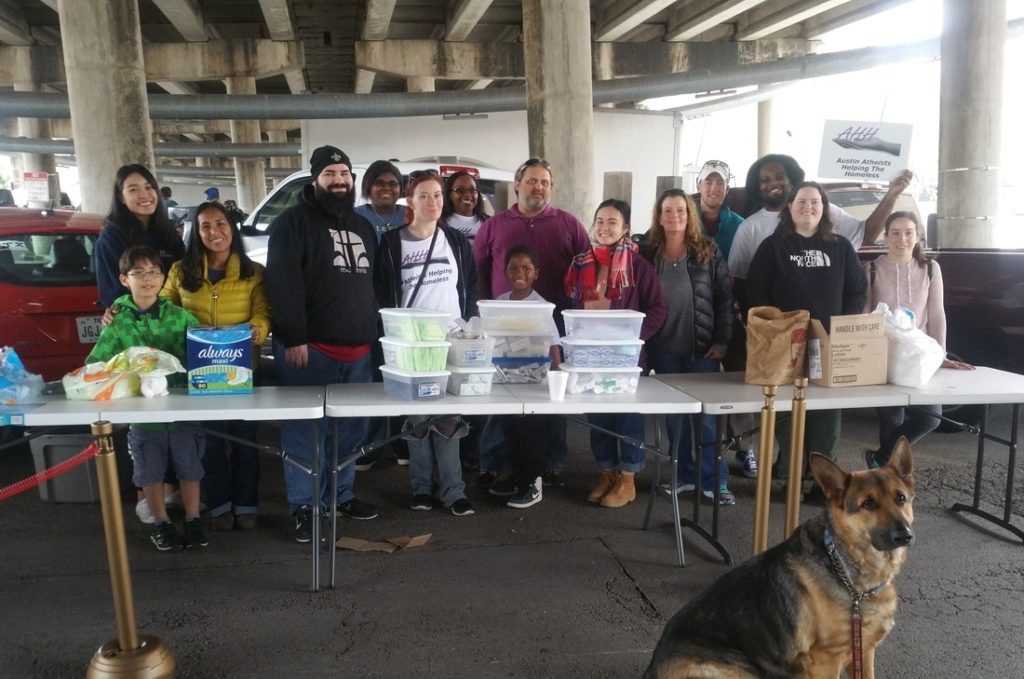 Austin AHH distributes food at a monthly giveaway.