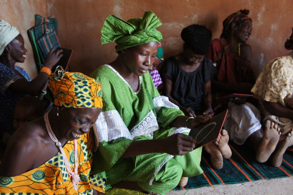 tandana foundation women literacy bright green headdress group sitting on floor