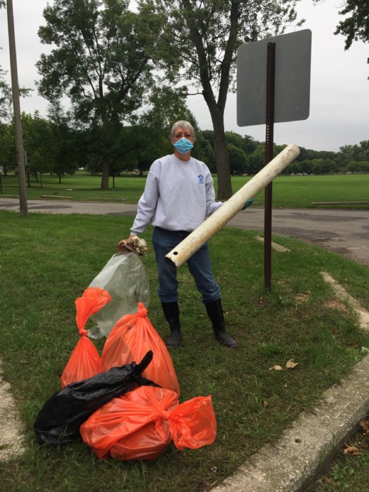 A secular voluteer from Center for Inquiry Michigan picks up somem trash at the Grand River